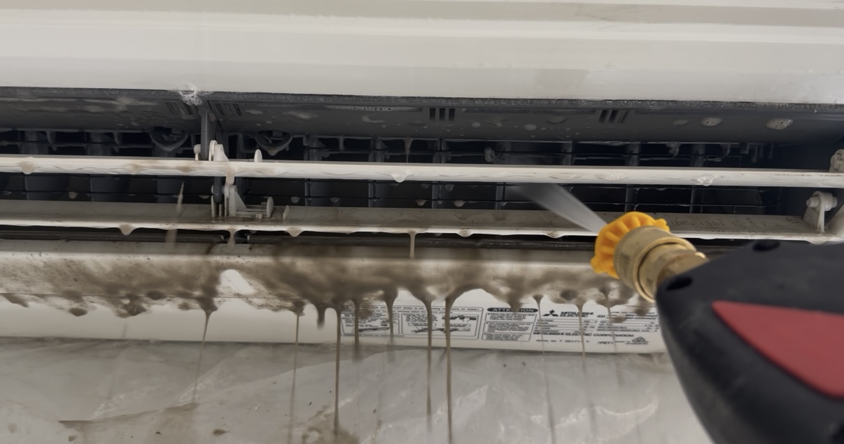 AirEffect technician cleaning a heat pump