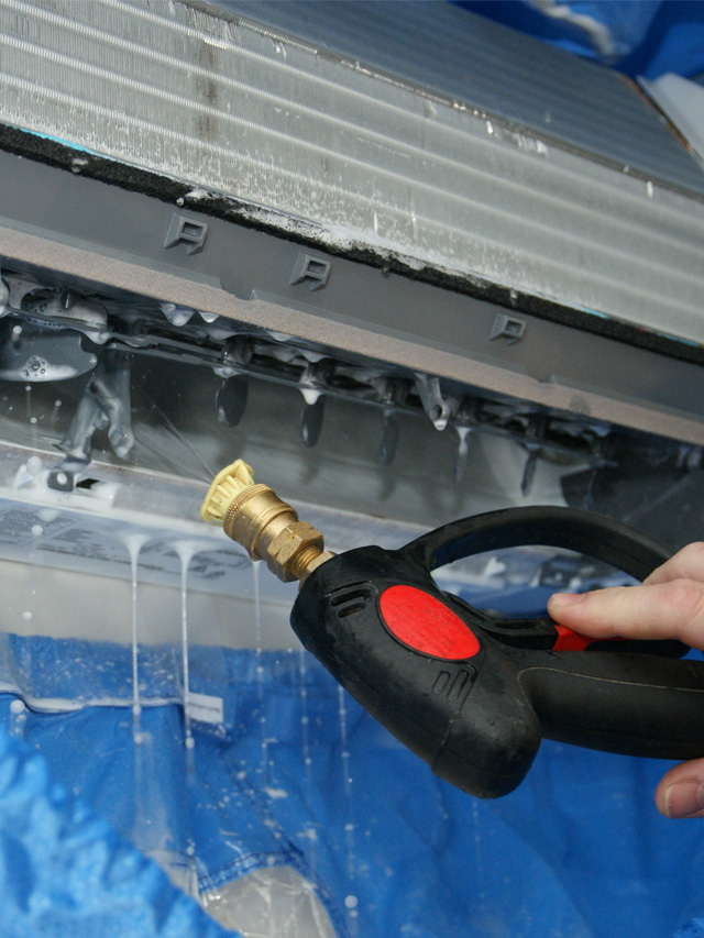 Dirty heat pump coil being cleaned
